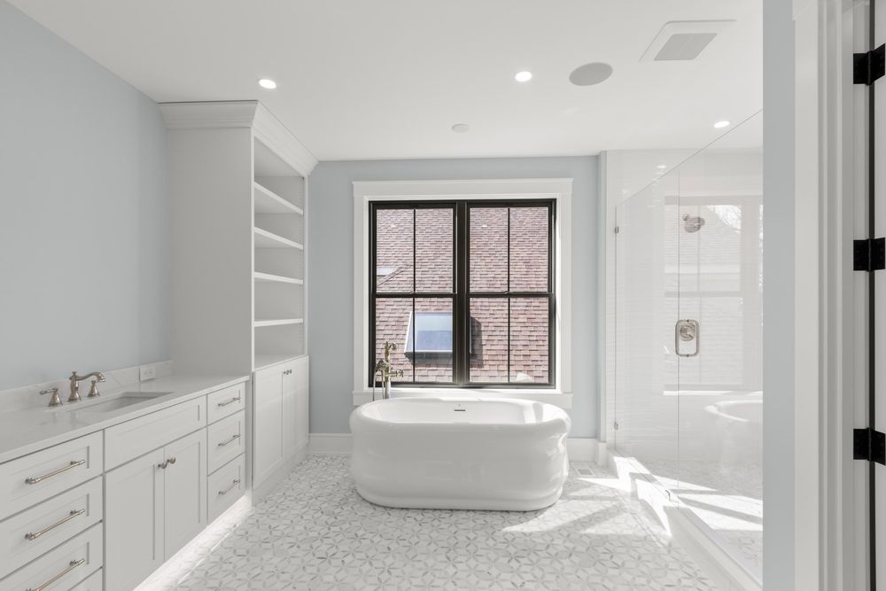 Primary bath with freestanding tub and black-frame window